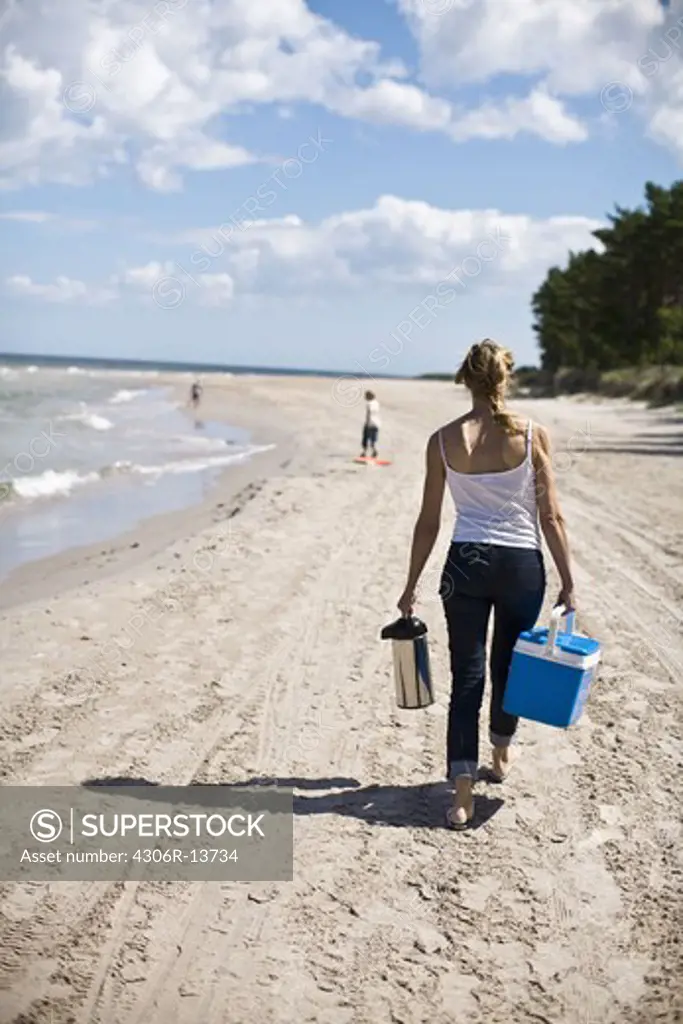 Mother and children walking on a beach, Gotland, Sweden.