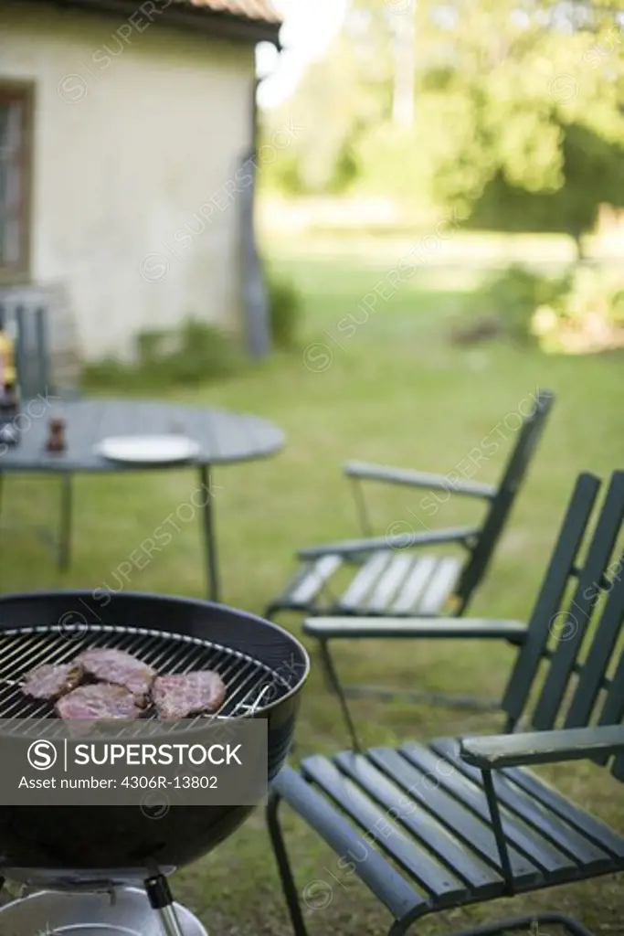 A grill and chairs in a garden, Sweden.