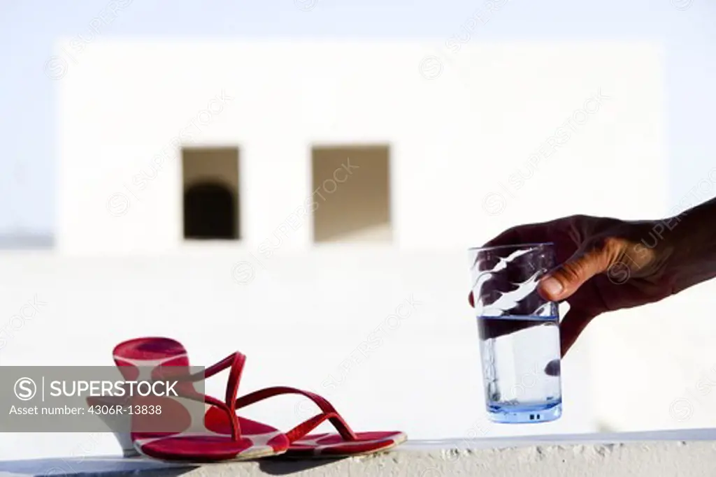 Glass of water and shoes, Greece.