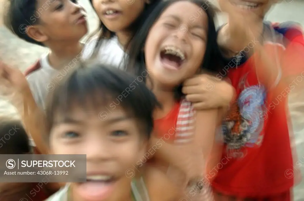 Happy children on a beach, the Philippines.