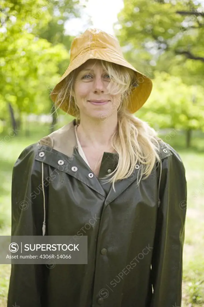 A blond woman in rain clothes, Sweden.