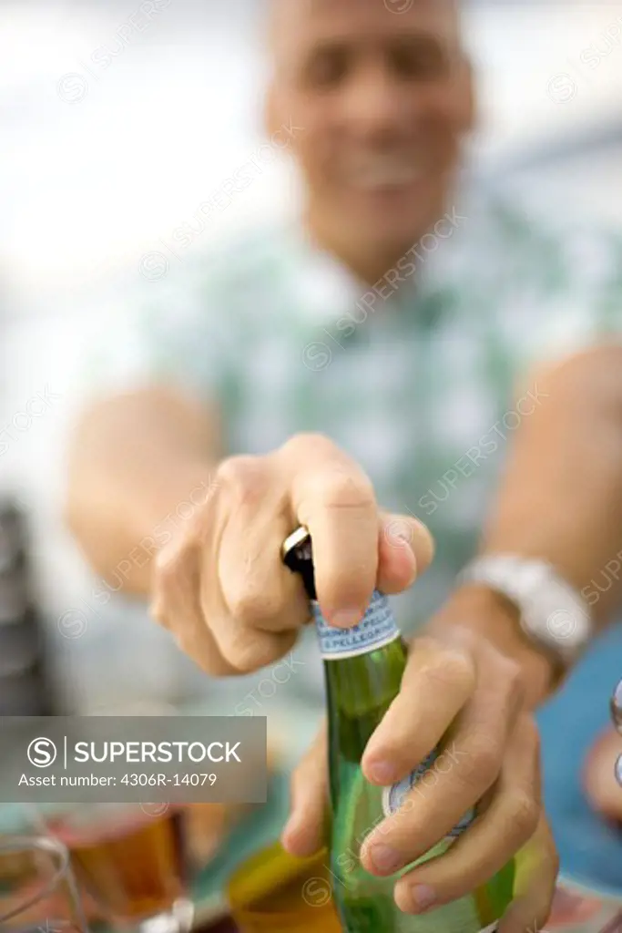 A man opening a bottle, Sweden.