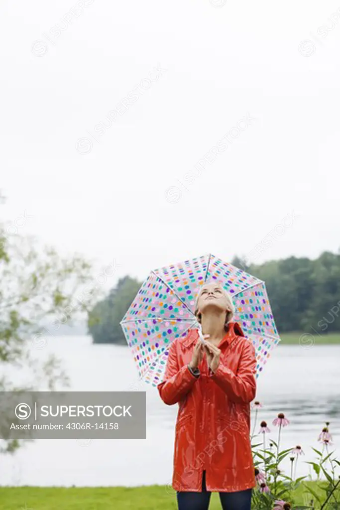 A woman with a dotted umbrella, Sweden.