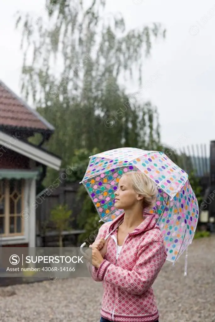 A woman under an umbrella, Sweden.