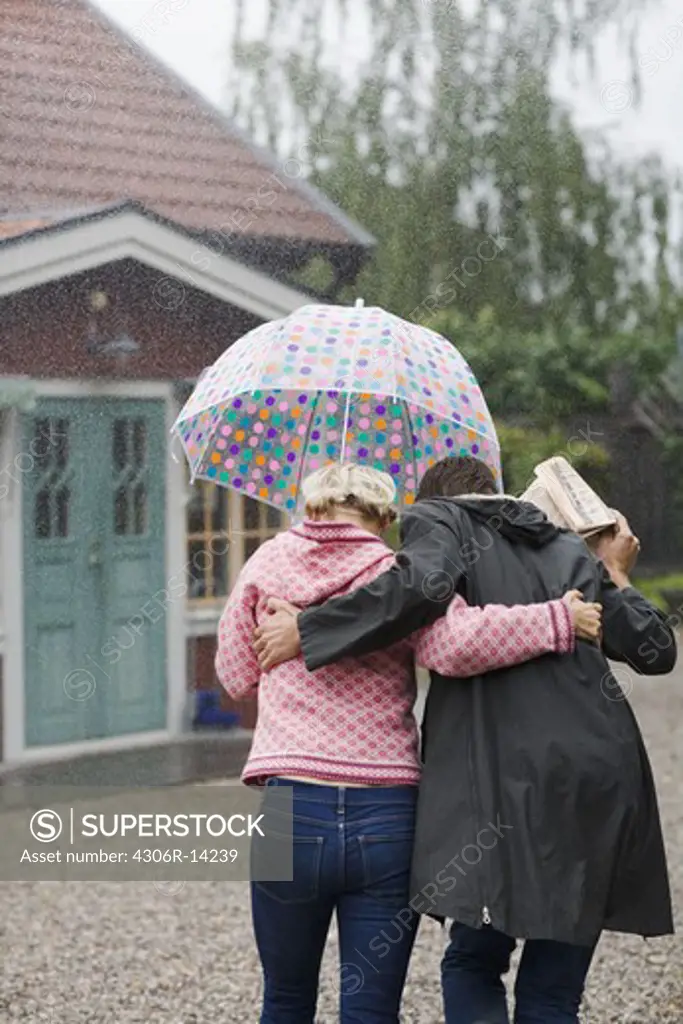 A man and a woman under an umbrella, Sweden.