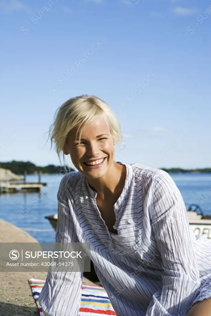 A woman on a cliff in the archipelago of Stockholm, Sweden.