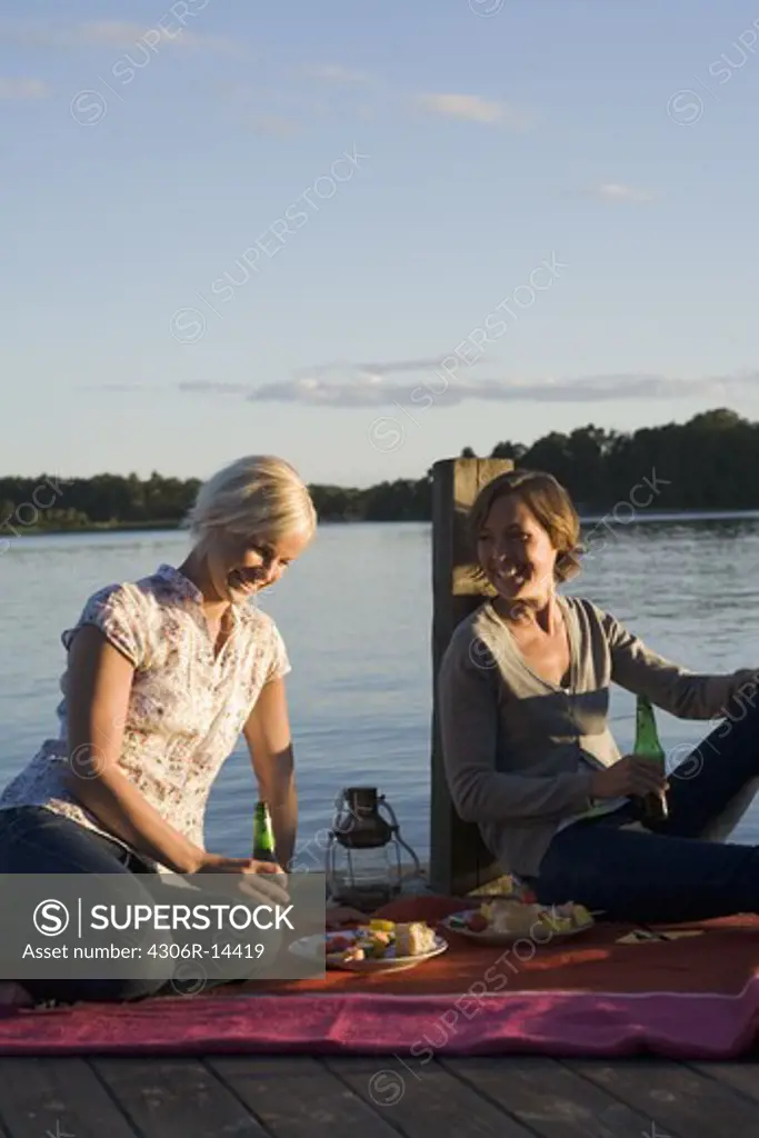 Two women by the sea in the archipelago of Stockholm, Sweden.