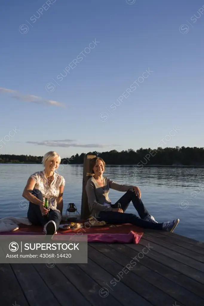 Two women by the sea in the archipelago of Stockholm, Sweden.
