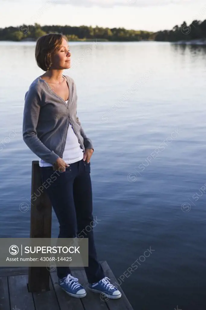 A woman by the sea in the archipelago of Stockholm, Sweden.