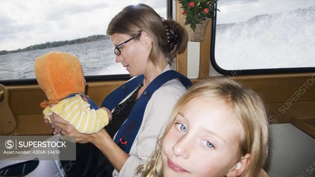 A woman with two children on a boat, Sweden.