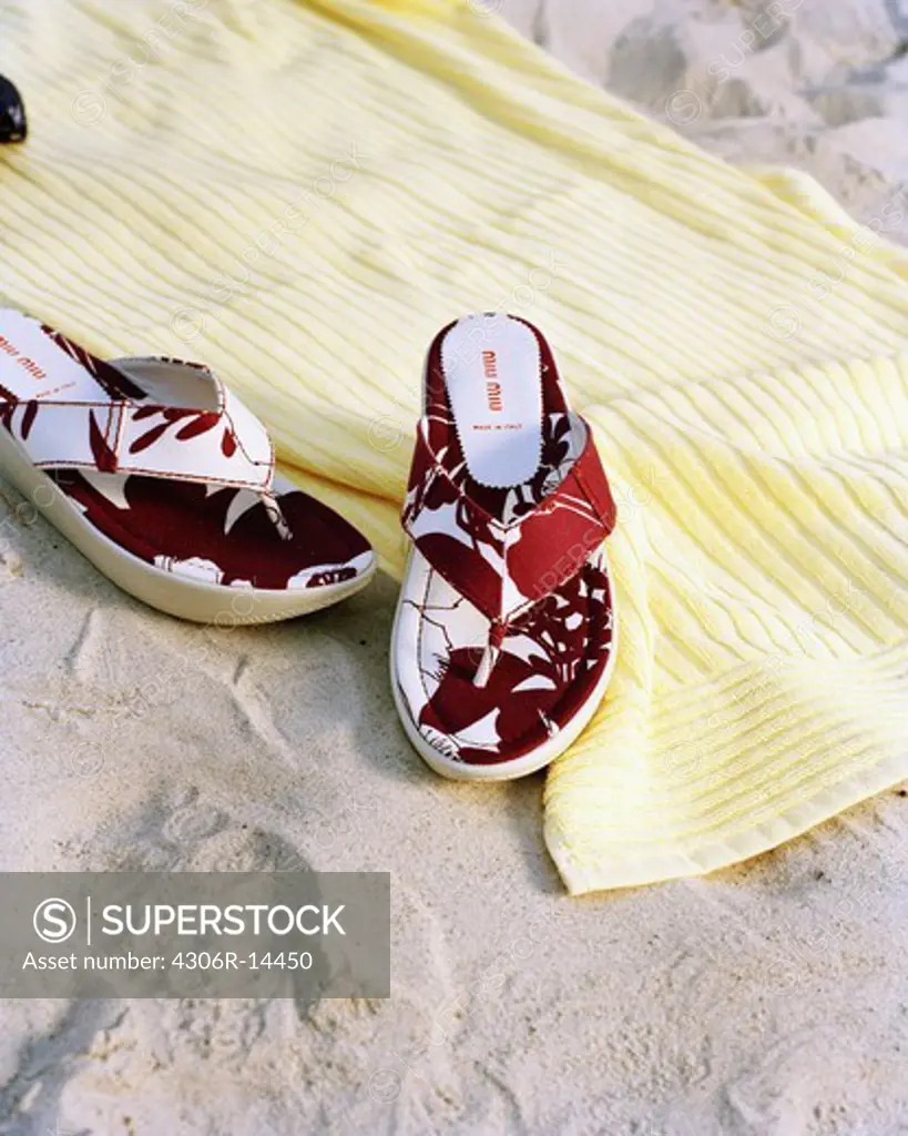 Summer shoes on a towel on a beach, Sweden.