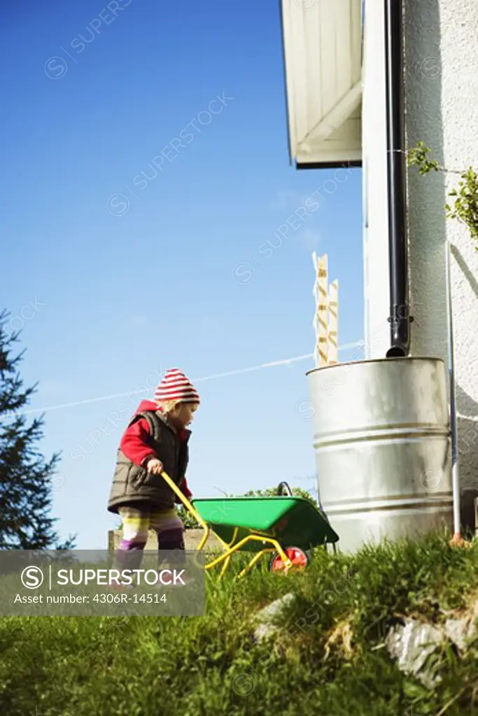 A child with a wheelbarrow, Sweden.