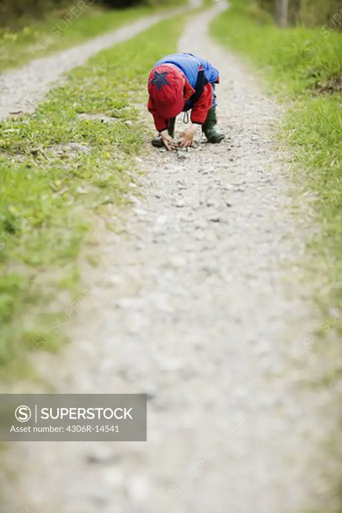 A boy on a dirt road, Sweden.
