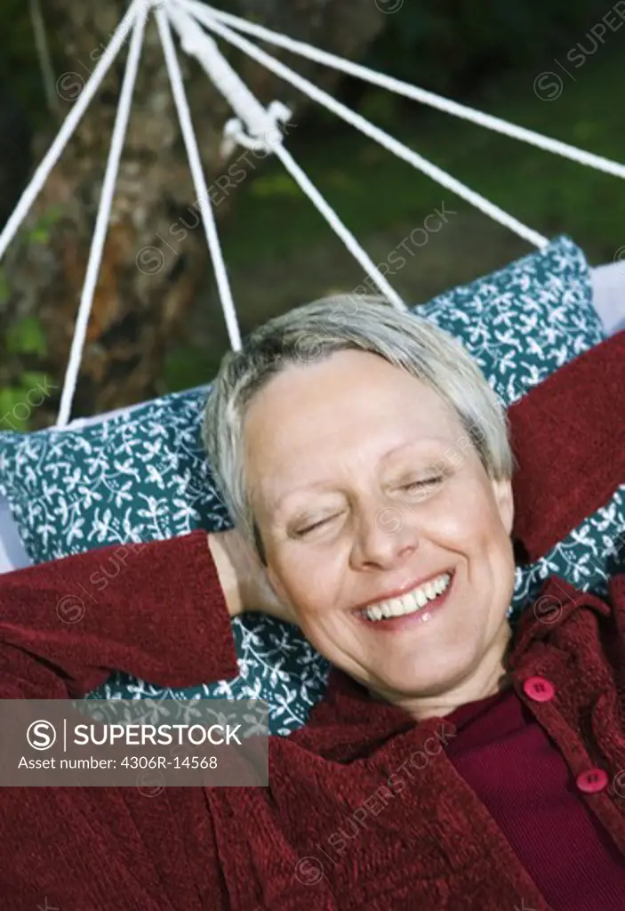 A woman in a hammock, Sweden.