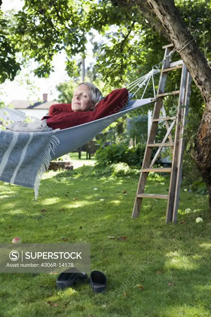 A woman in a hammock, Sweden.