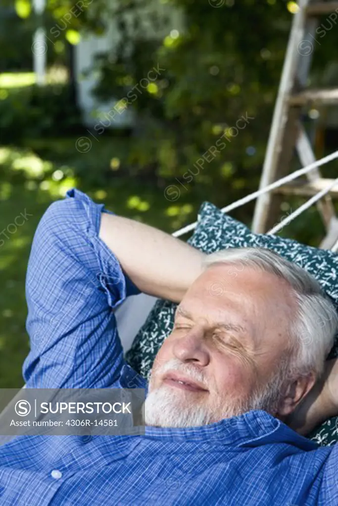 An old man in a hammock, Sweden.