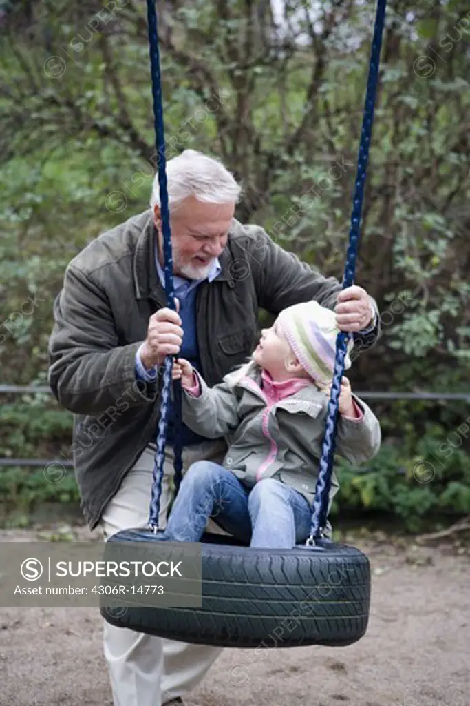 Grandfather, grandchild and a swing, Sweden.