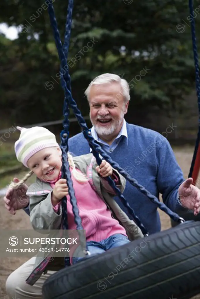 Grandfather, grandchild and a swing, Sweden.