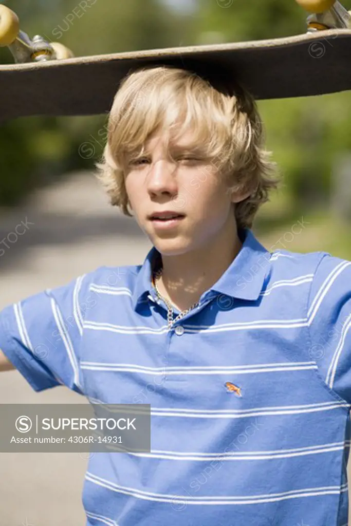 Portrait of a boy with a skateboard, Sweden.