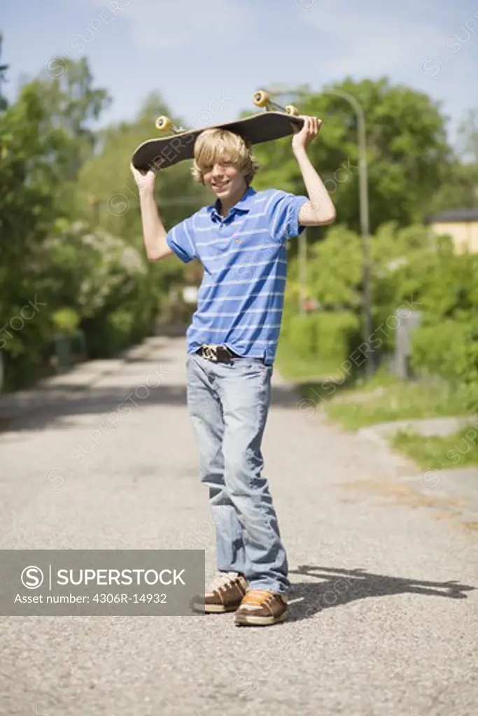 Portrait of a boy with a skateboard, Sweden.