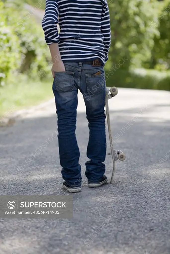 A teenager with a skateboard, Sweden.