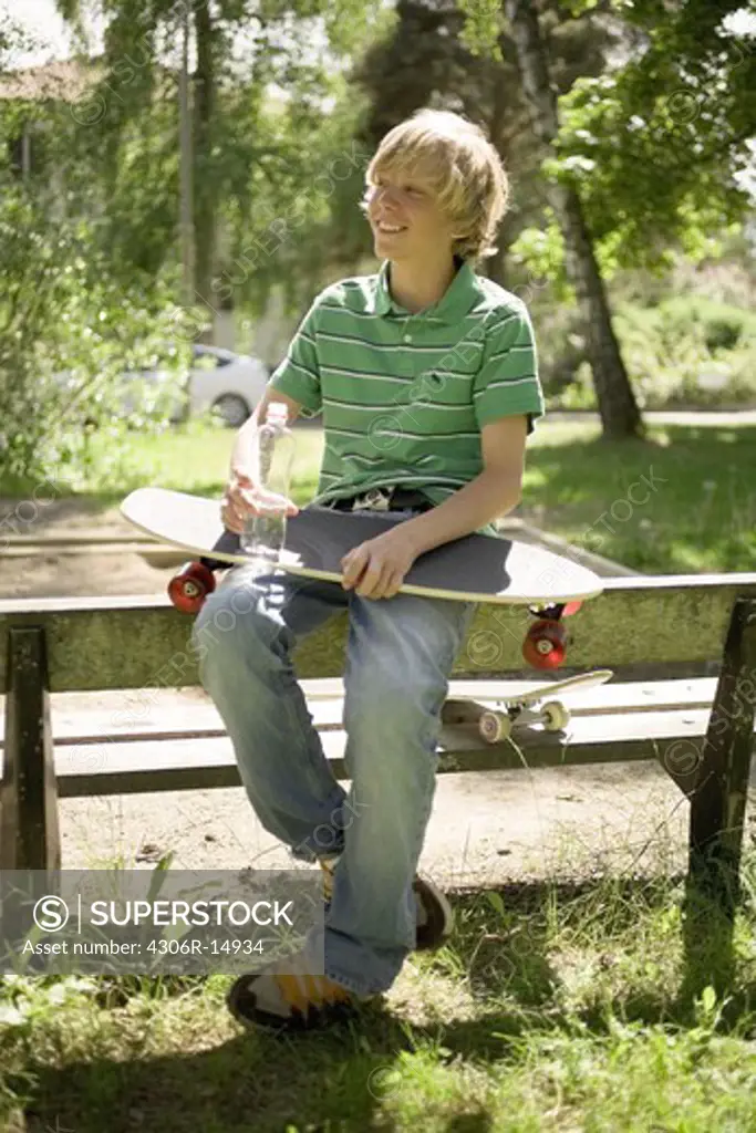 Boy with a skateboard in his knee, Sweden.