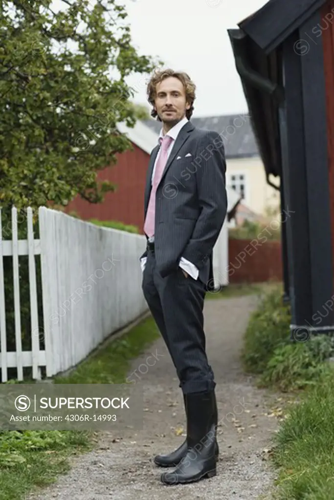 A man in a suit on the countyside, Sweden.