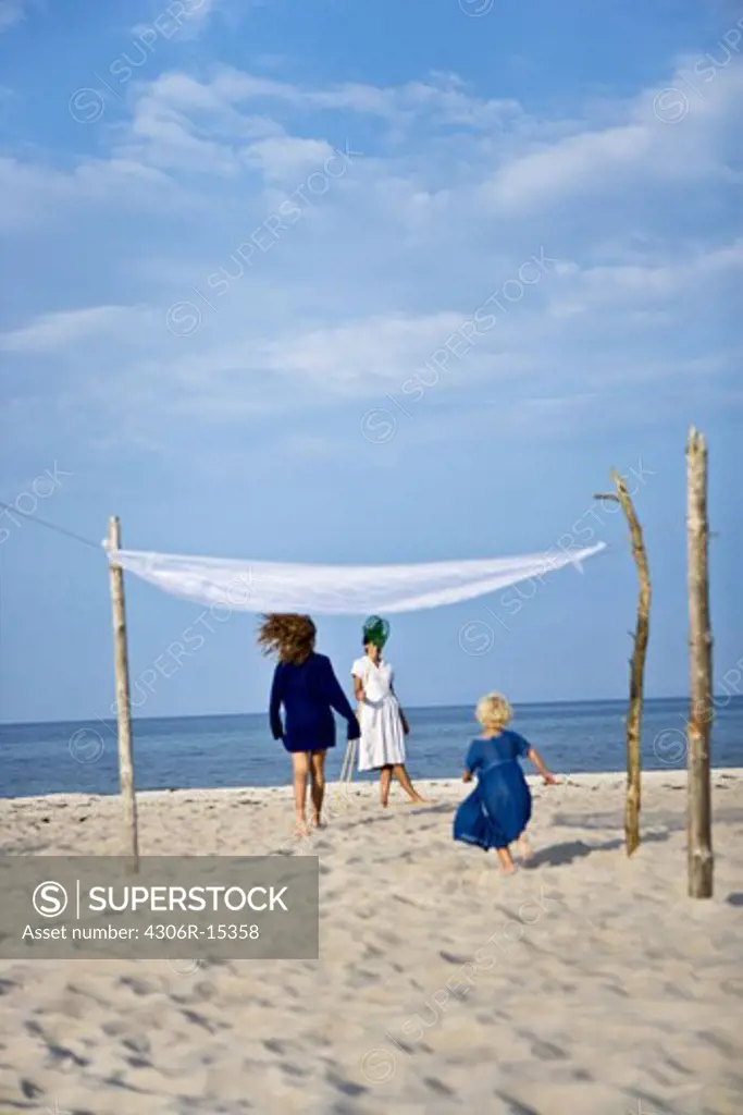 Mother and daughters on the beach, Sweden.