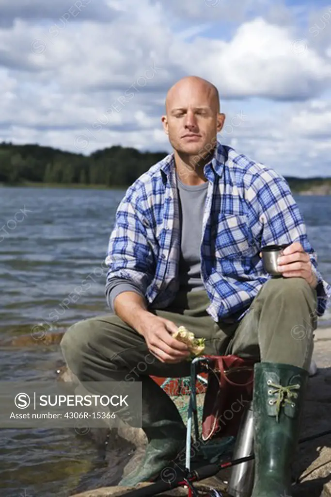 Portrait of a smiling man by the water, Sweden.