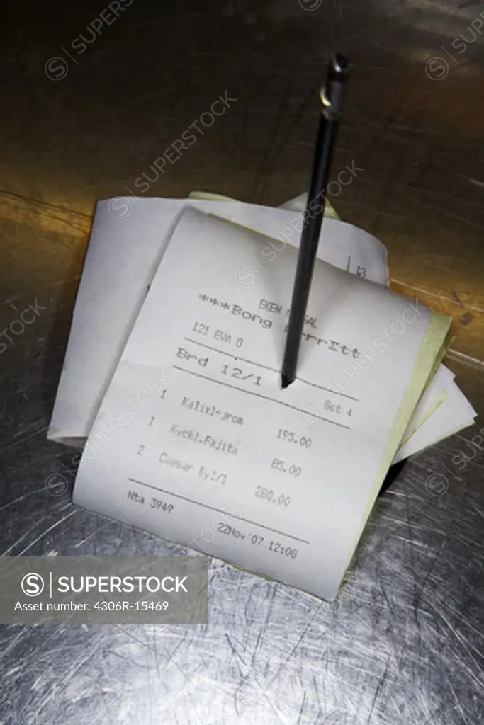 Coupons in a restaurant kitchen, close-up.