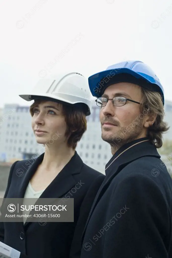 Project leaders at a building site, a man and a woman, Sweden.