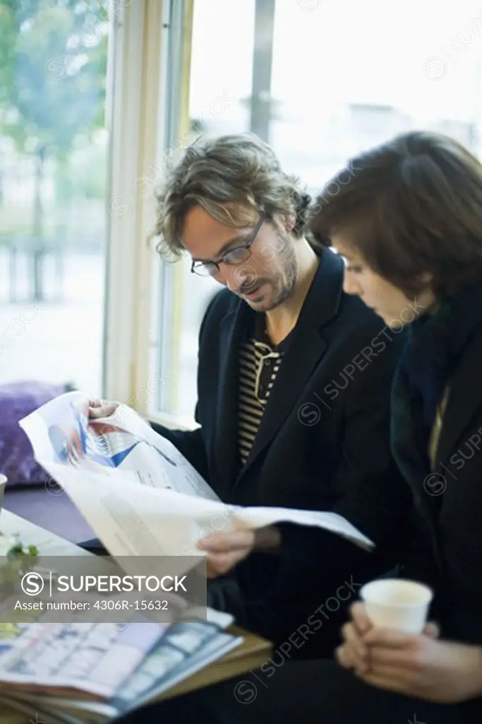 A businessman and a business woman having a meeting, Sweden.