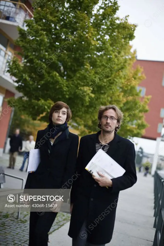 A businessman and a businesswoman walking, Sweden.