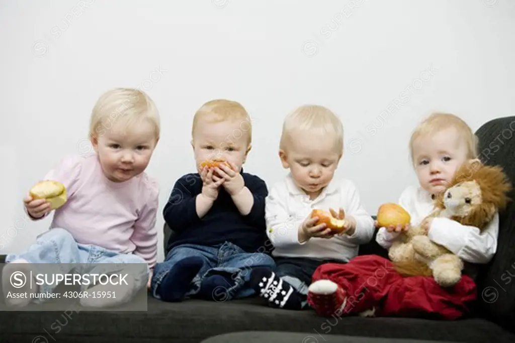 Four babies with apples, Sweden.