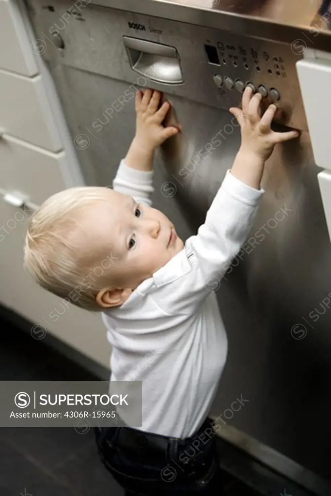 A baby closing the dishwasher, Sweden.