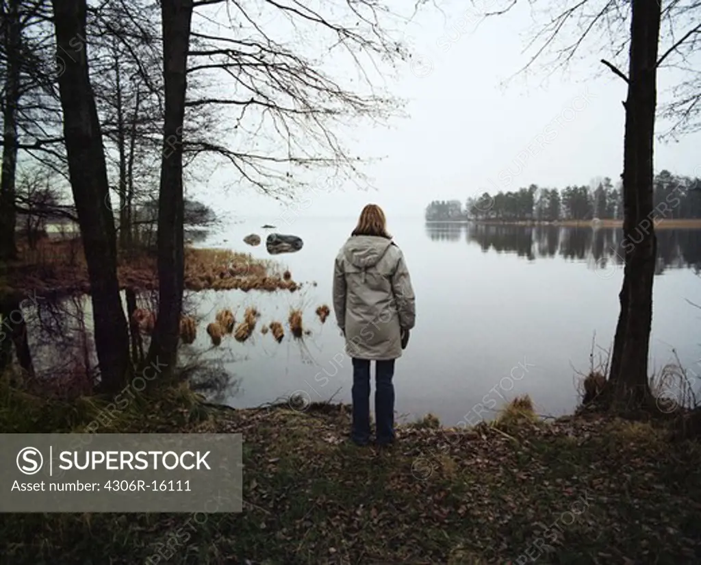 A lonely woman by a lake, Sweden.