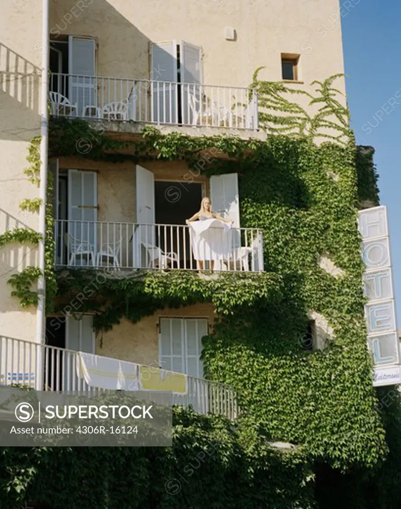 A woman on a balcony, France.