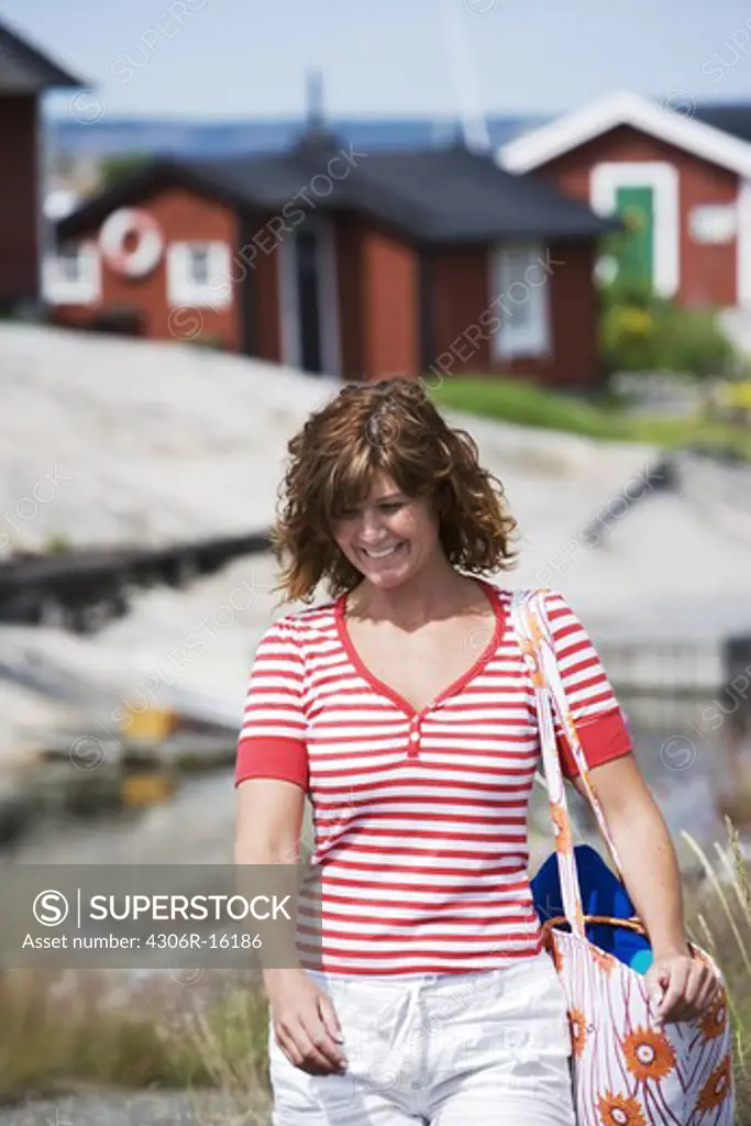 A woman walking in the archipelago of Stockholm, Sweden.