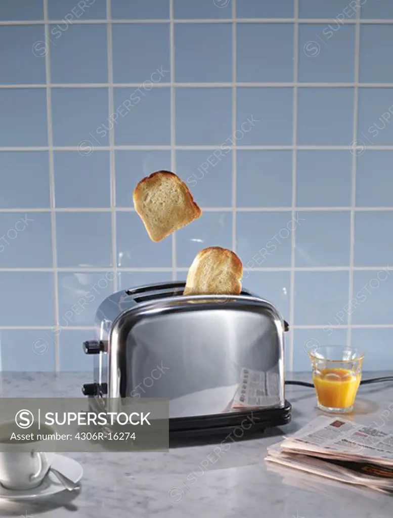 Toasted bread coming out of toaster in domestic kitchen