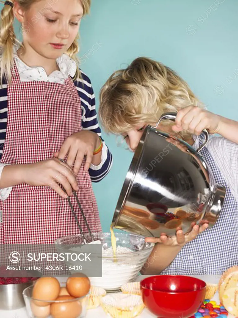 Children baking cakes, Denmark.