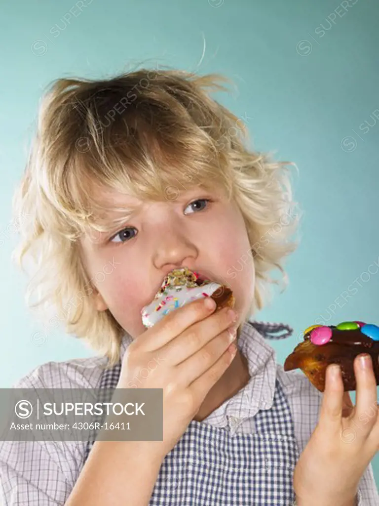 A boy eating a muffin, Denmark.