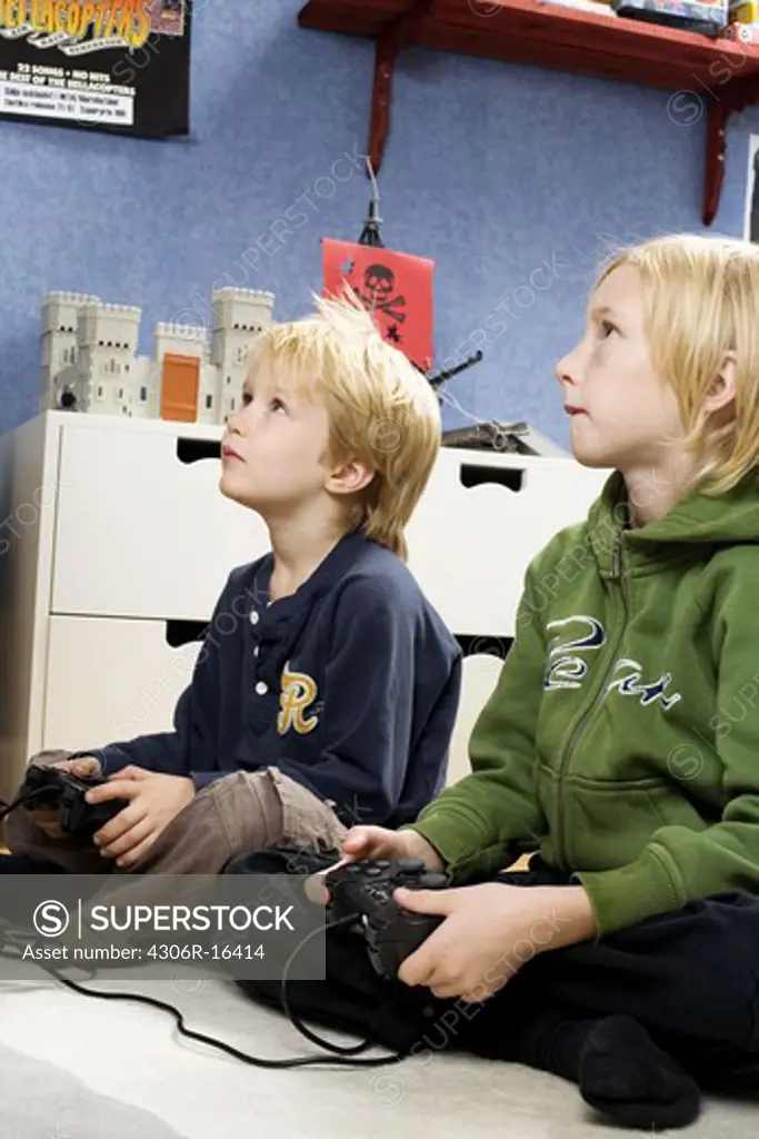Two Scandinavian boys playing video games, Sweden.
