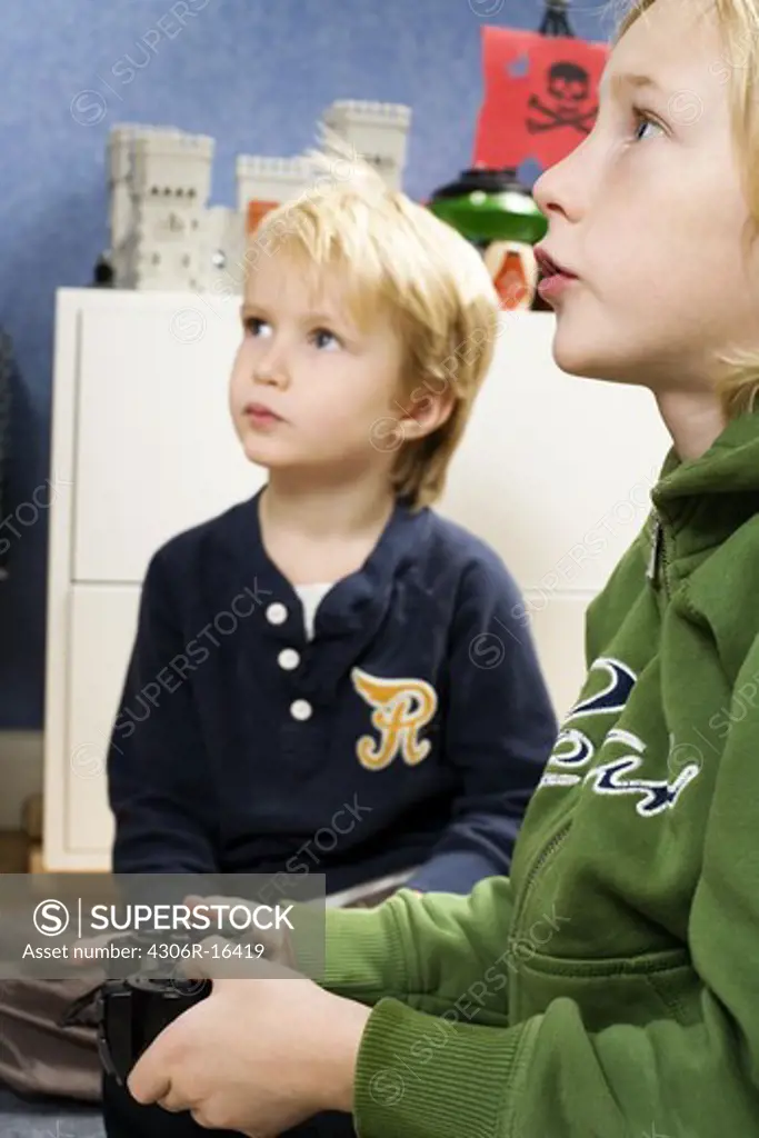 Two Scandinavian boys playing video games, Sweden.