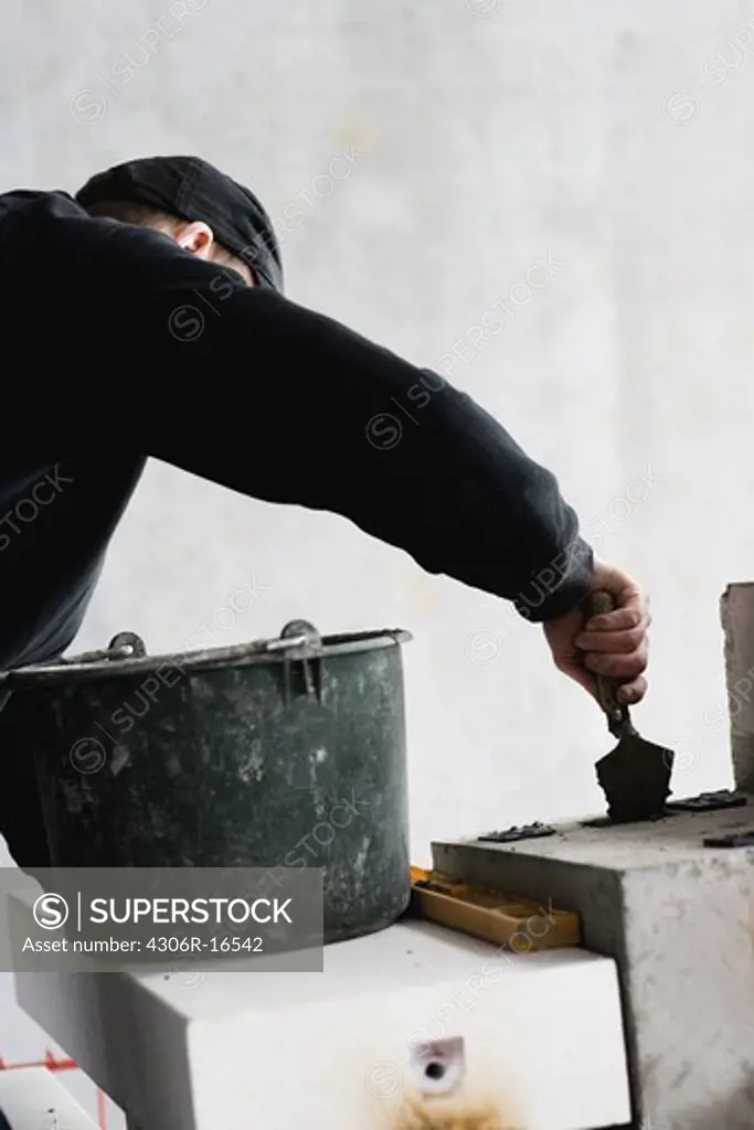 A mason at a building site, Sweden.