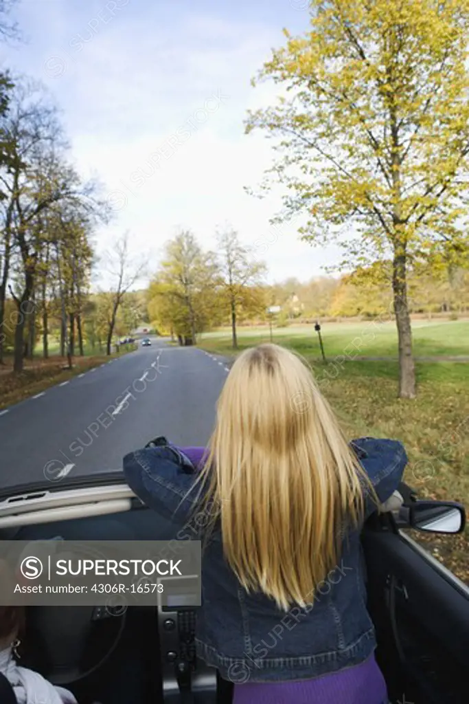 A young Scandinavian woman in a cabriolet, Sweden.
