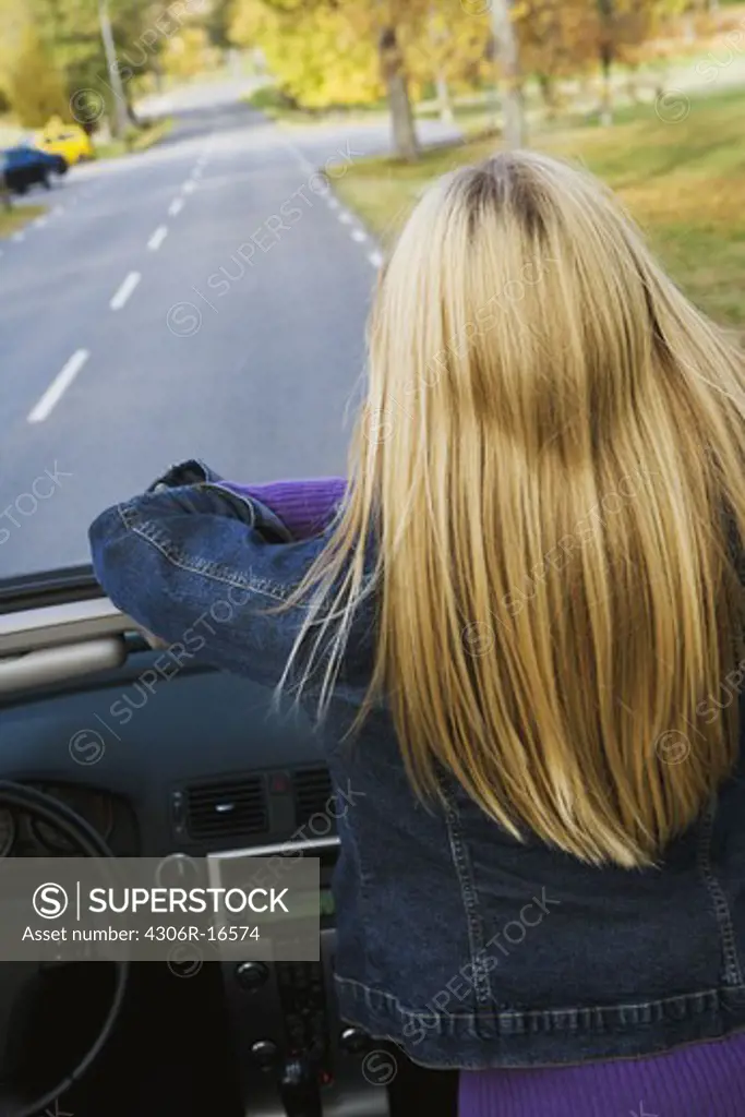 A young Scandinavian woman in a cabriolet, Sweden.