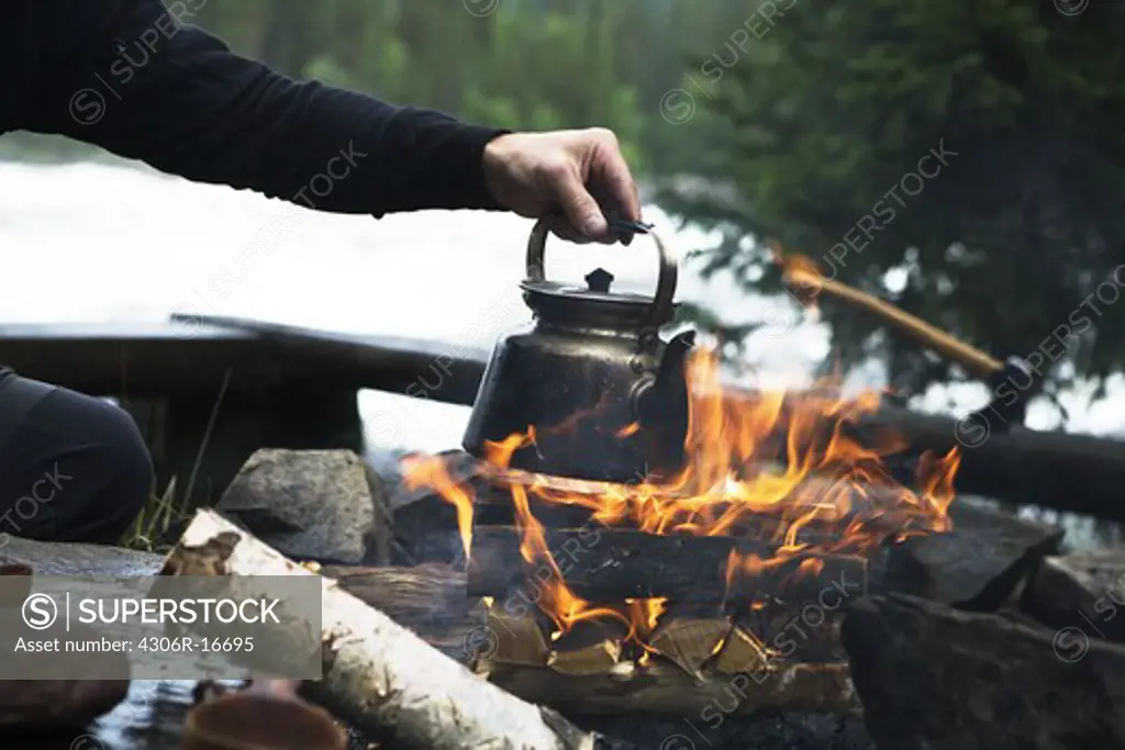 Making coffee over a camp fire, Sweden.