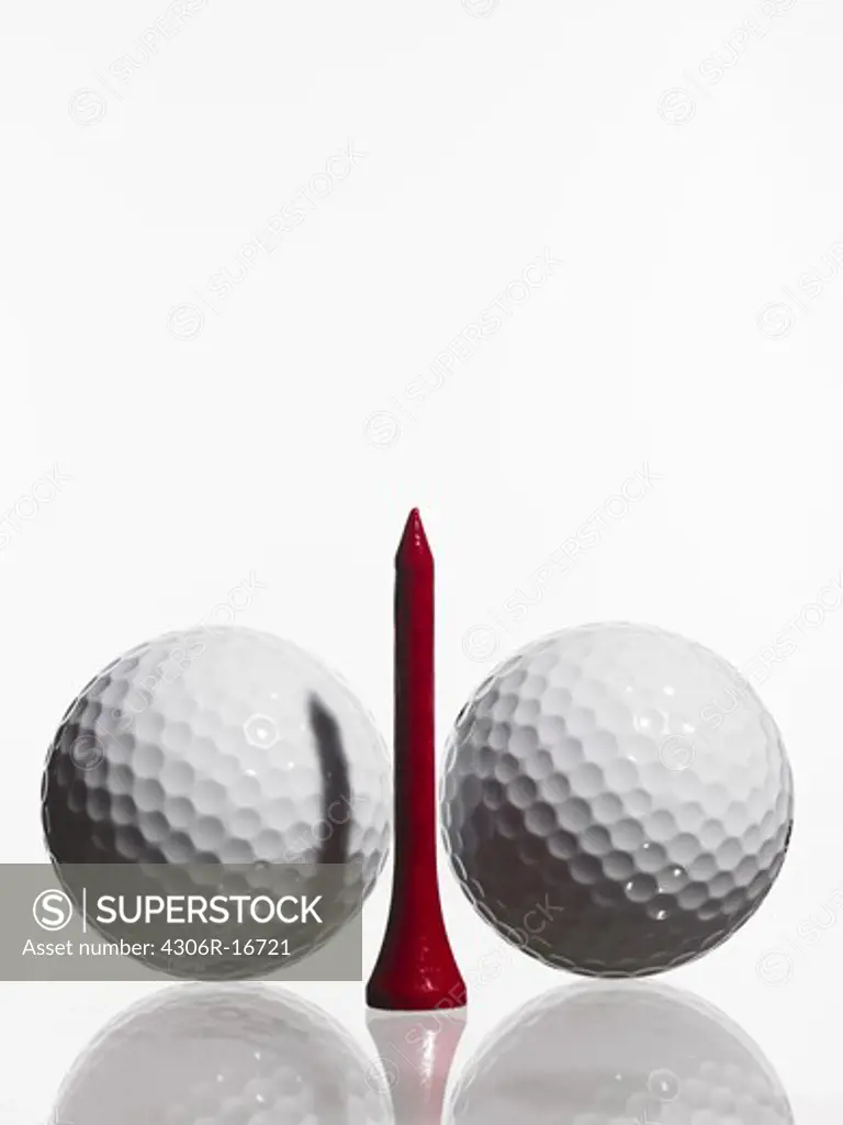 Two golf balls and a tee.