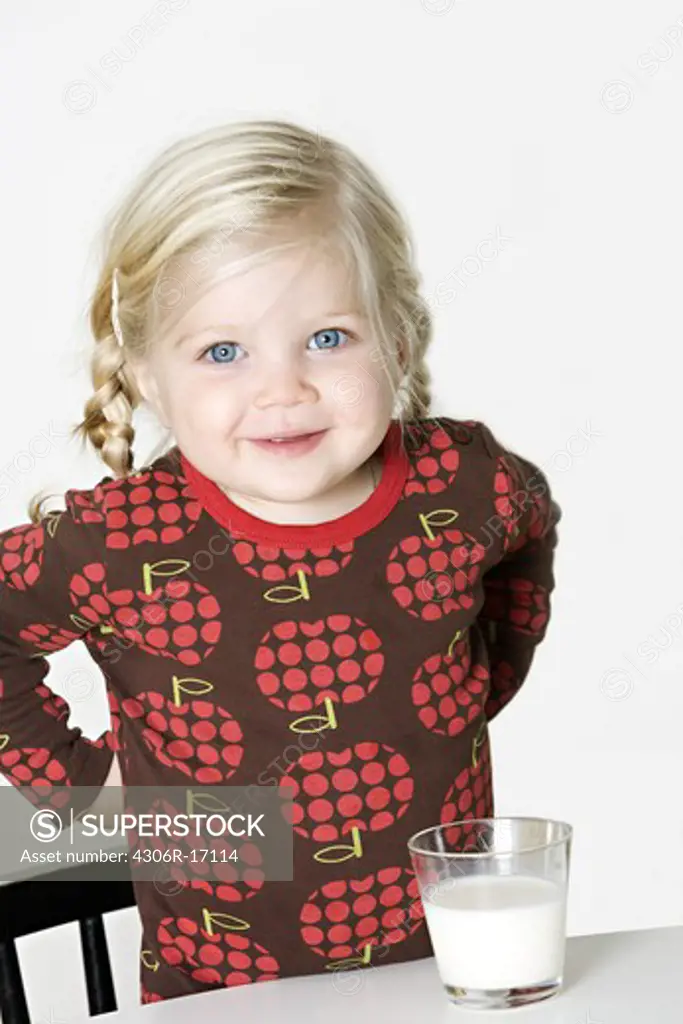 A blond Scandinavian girl drinking milk, Sweden.