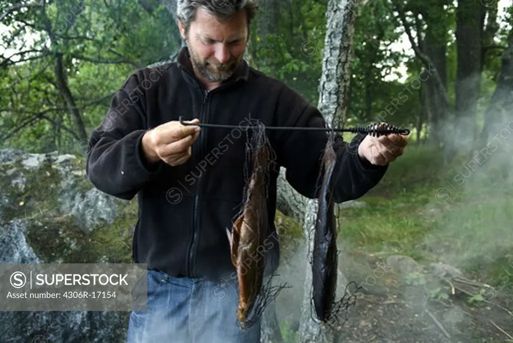 A man smoking fish, Sweden.